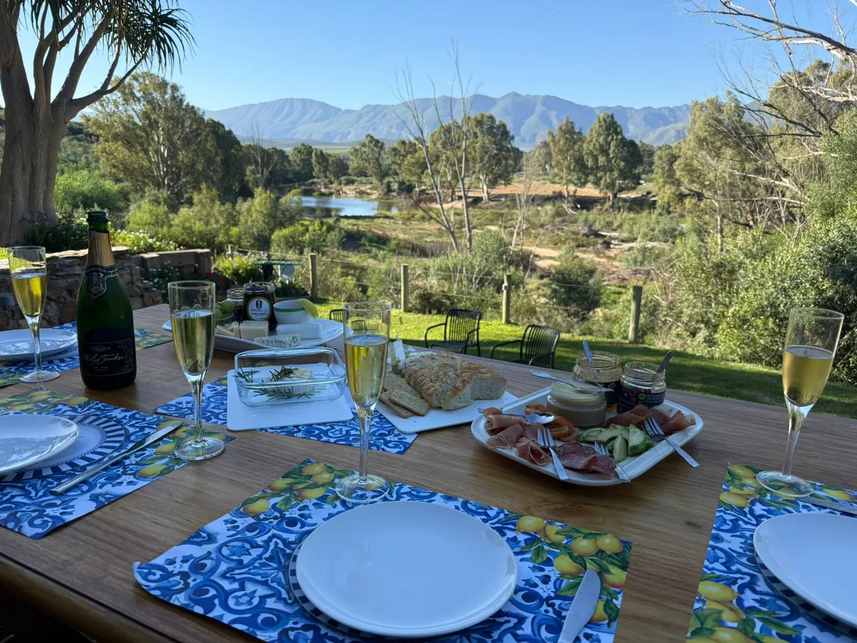 Dining table with Breede River views at Riverhide private villa