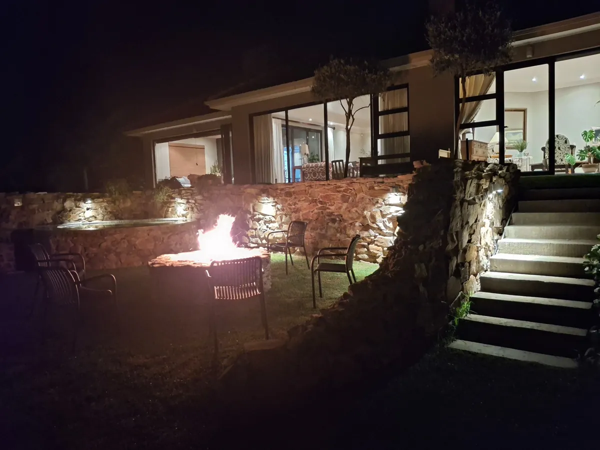 Riverhide outdoor firepit and villa at night